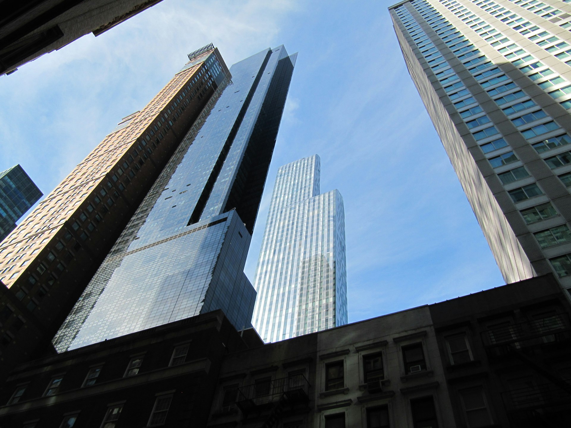 looking up at tall buildings in a city